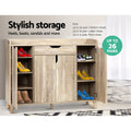 Oak shoe cabinet outer doors open showing coloured shoes on shelves stylish storage up to 26 pairs badge lifestyle setting