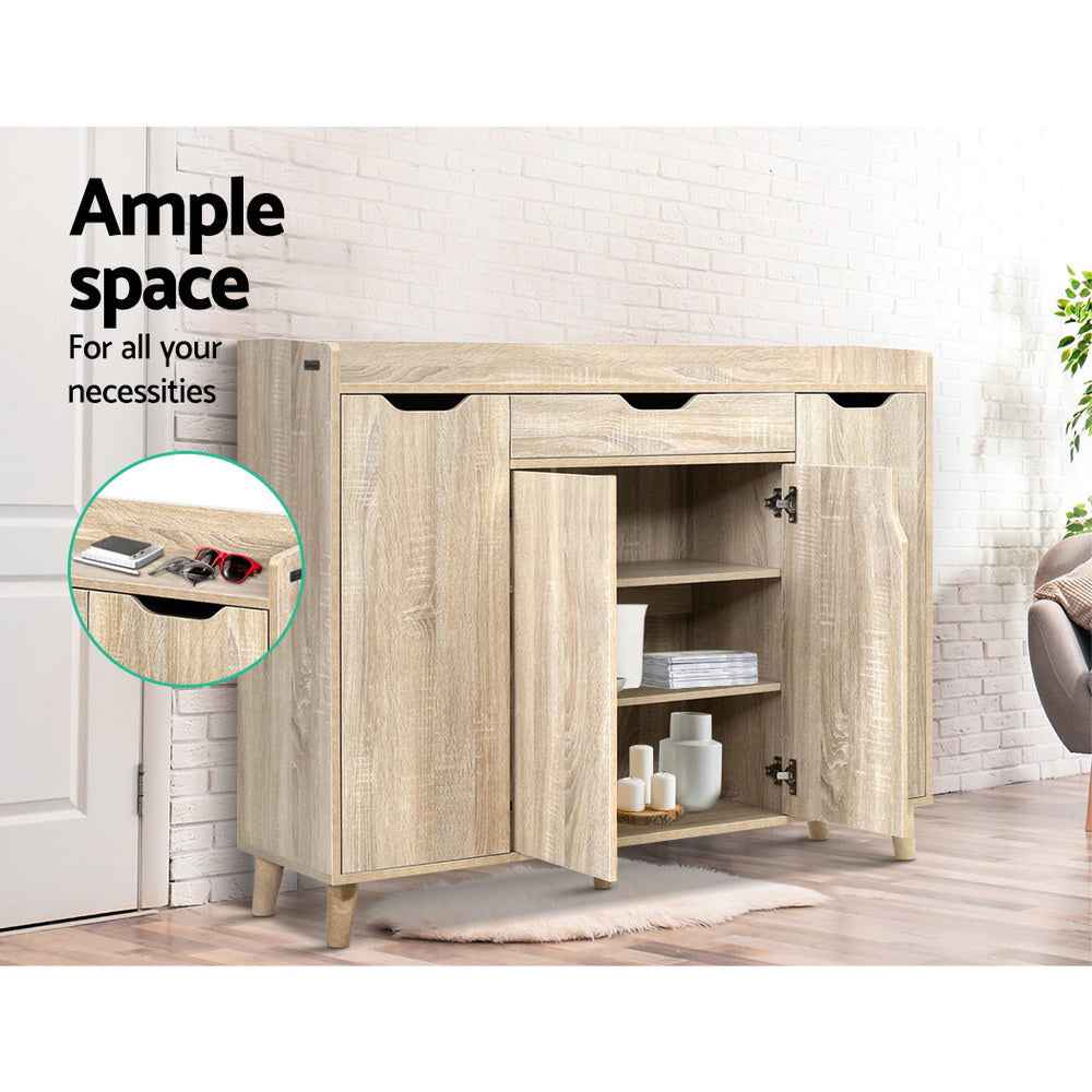 Oak shoe cabinet in hallway lifestyle right door open showing shelves with decor items drawer inset with keys and sunglasses