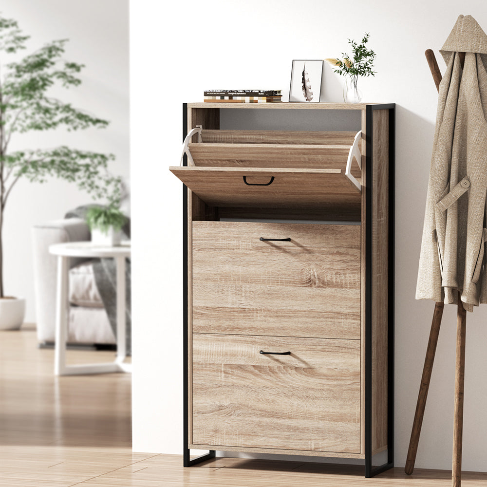 Oak finish shoe cabinet with black metal frame three flip-down compartments and open top shelf in hallway lifestyle setting