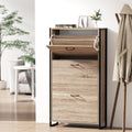 Oak finish shoe cabinet with black metal frame three flip-down compartments and open top shelf in hallway lifestyle setting