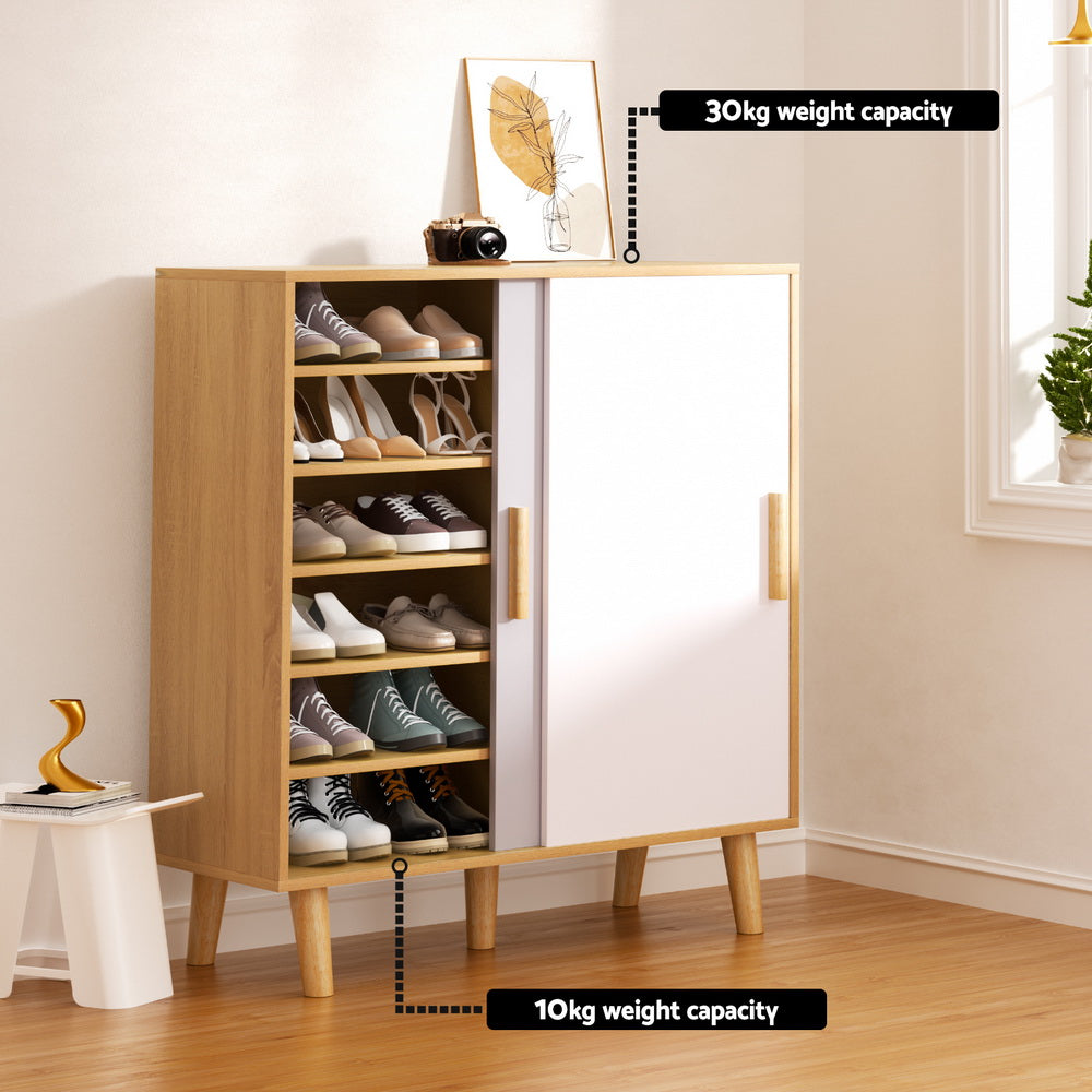 Oak sliding door shoe cabinet open showing shoes with 30kg top and 10kg leg weight capacity labels