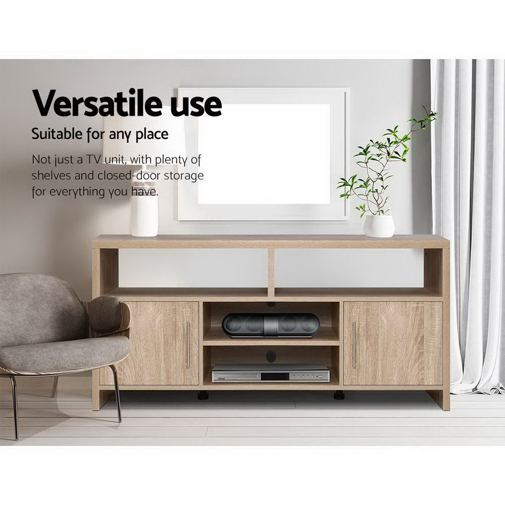 Oak TV stand 140cm versatile use lifestyle in grey room with grey armchair vases and disc player on shelves