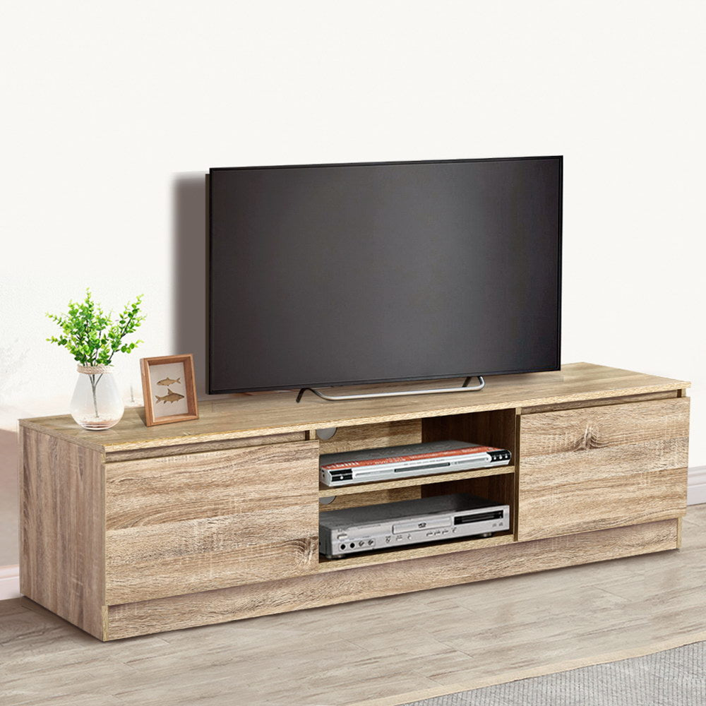 Oak TV stand 160cm lifestyle in cream room with TV disc players and fish picture frame on surface