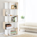 Oak and white S-shaped 5-tier display shelf in living room styled with books, vase and plant beside cream sofa