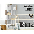 Oak and white S-shaped 5-tier shelf in Scandinavian kids room with books and wooden crates; text reads Creative decor
