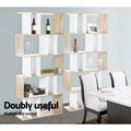 Two oak and white S-shaped 5-tier shelves as dining room divider with wine bottles and glasses; text reads Doubly useful