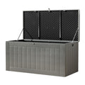 Grey outdoor plastic deck box with lid fully open, three-quarter angle view on white background