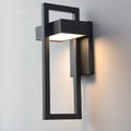 Black rectangular framed outdoor wall light mounted on grey wall glowing warm downward, full front view on neutral background