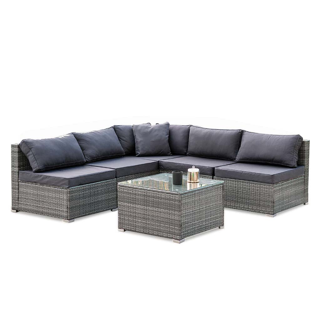 5-piece grey wicker outdoor sectional sofa with dark grey cushions in L-shape and glass coffee table, white background