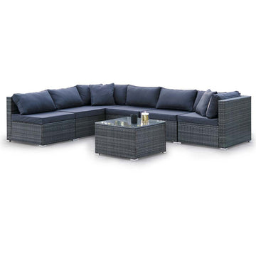 6-piece dark grey wicker outdoor sectional sofa set with navy cushions in L-shape and glass-top coffee table