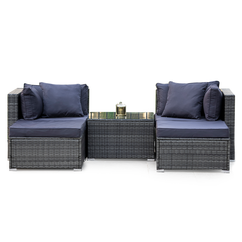 4-piece outdoor wicker set with two armless chairs and glass coffee table, grey wicker with navy cushions, white background