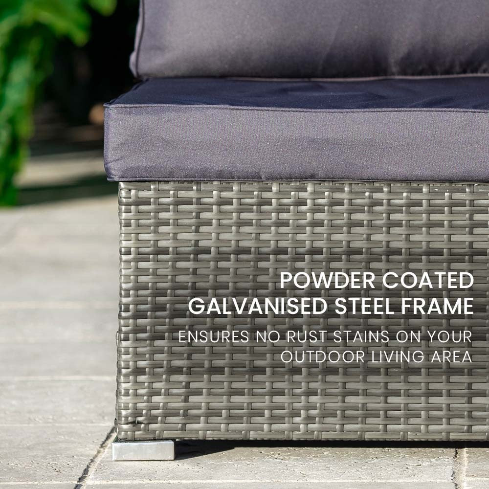 Close-up of dark grey wicker sofa base on patio with text: powder coated galvanised steel frame ensures no rust stains