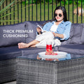Woman in denim jacket relaxing on grey outdoor wicker sofa reading outdoors with text: Thick premium cushioning