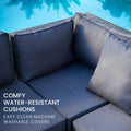 Wicker sofa corner seat with navy cushions by poolside and text: comfy water-resistant cushions easy clean machine washable