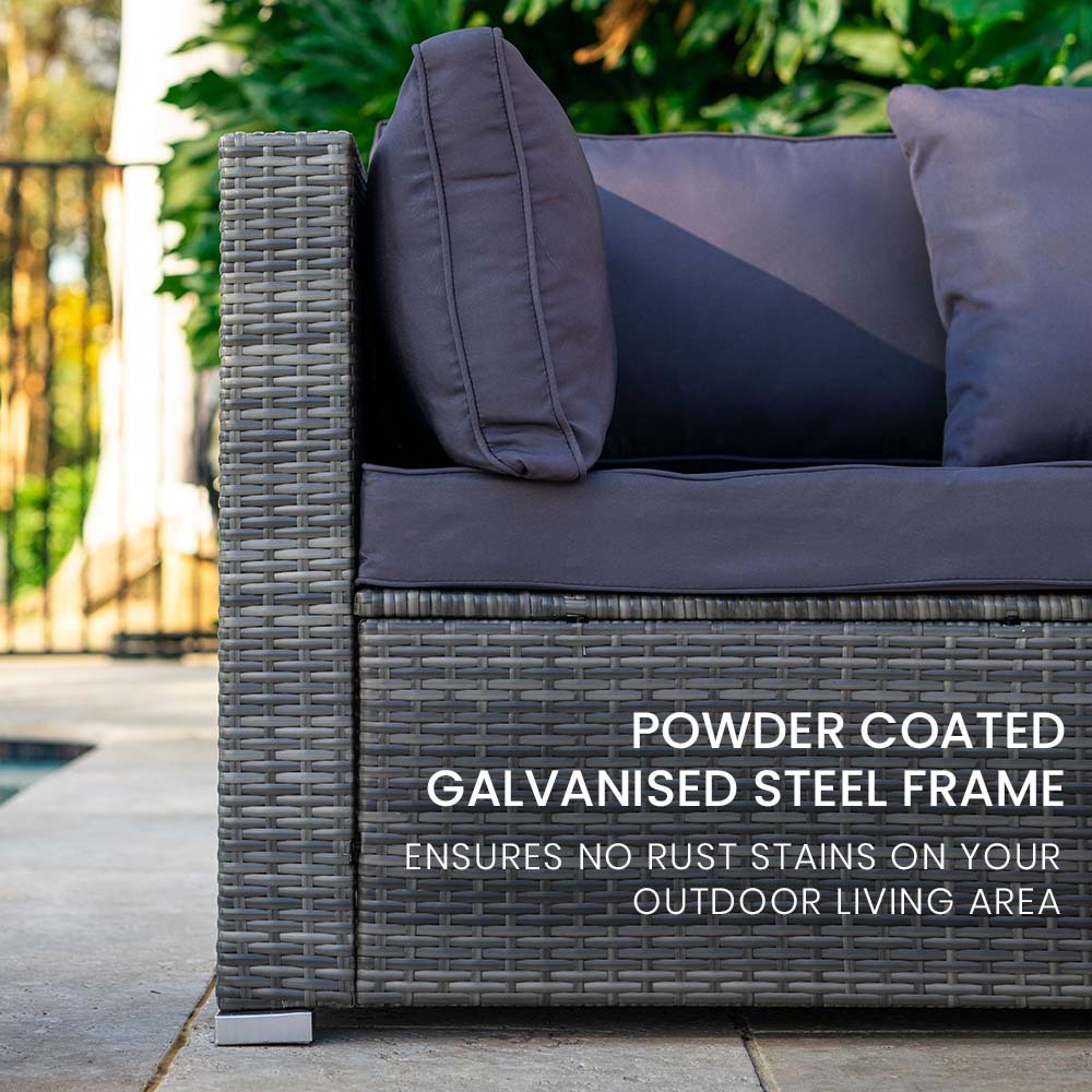 Close-up of outdoor wicker sofa end with grey cushions and text: powder coated galvanised steel frame no rust stains