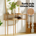 Oak oval console table in hallway setting with vase and lamp on top, bowls on shelf, text: Rustic style console table