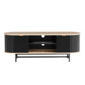 Oval oak-top black fluted TV unit front view on white two fluted doors center shelves cable hole black X-frame legs