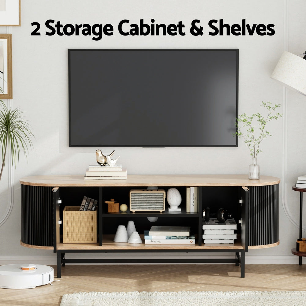 Oval oak-top black TV unit storage lifestyle both doors open wicker basket radio books and robot vacuum below