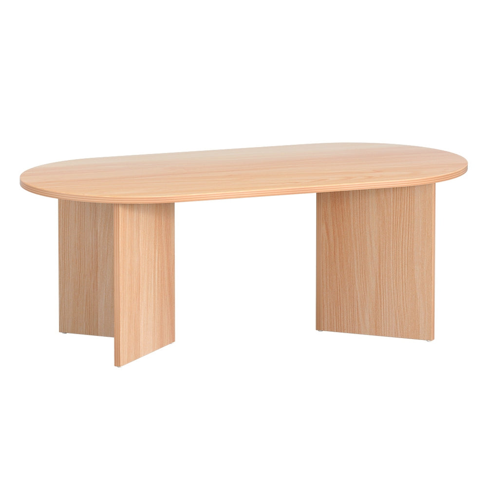 Oval natural wood coffee table three-quarter angle view on white background with T-shaped panel legs