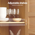 Close-up of pine sideboard interior shelf with wine glasses and dishes, adjustment holes visible, text Adjustable shelves