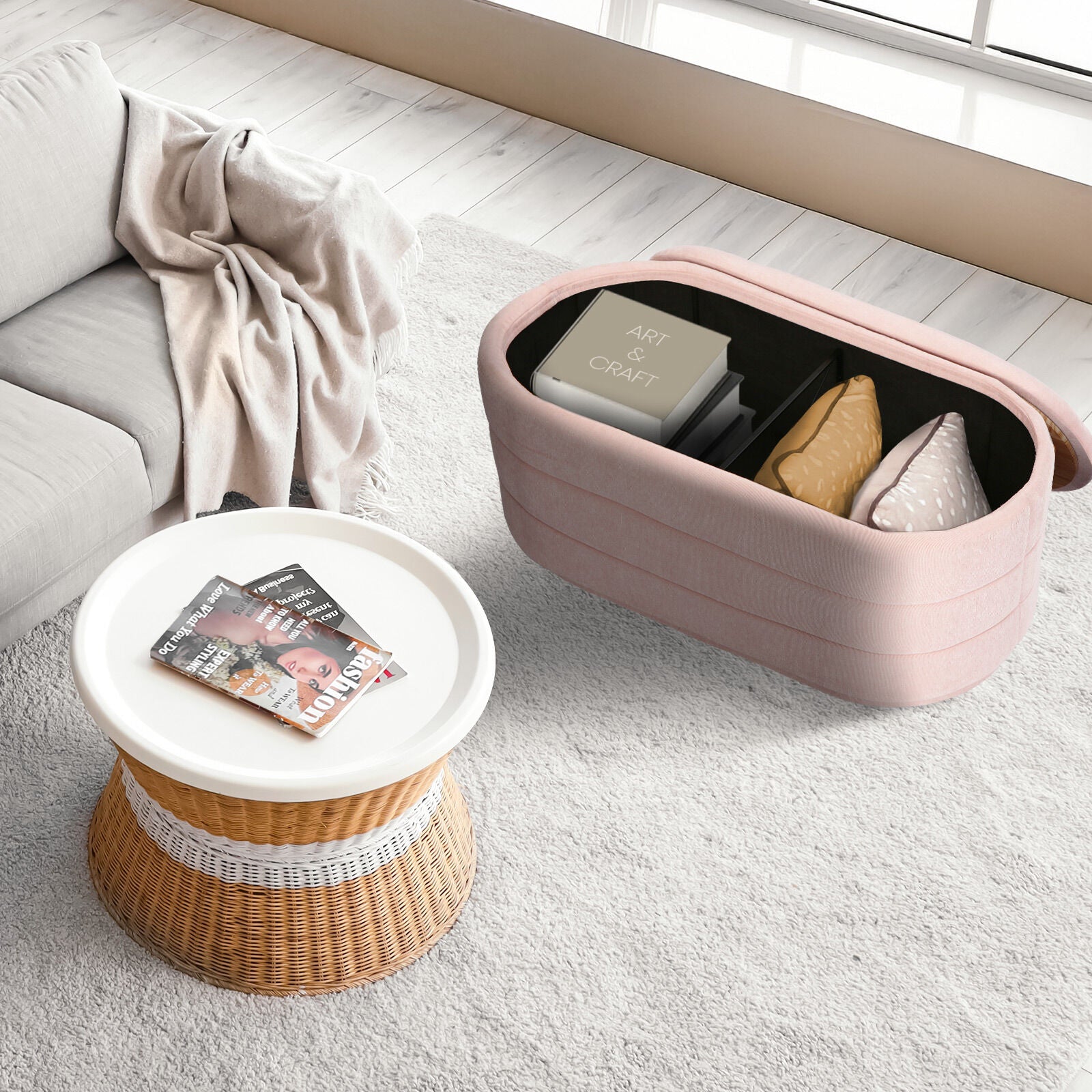 Pink storage ottoman open with lid off showing black interior holding an Art and Craft box and cushion in living room