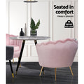 Pink velvet scallop shell armchair rear view at round marble table with 150kg max load badge in white panelled room
