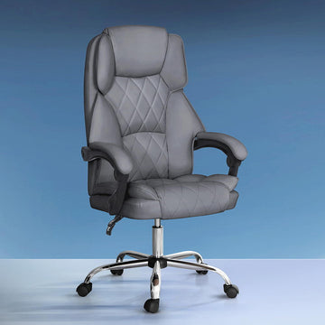 Grey PU diamond-stitch high-back executive chair with chrome base on blue gradient studio background