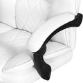 Close-up of white PU leather armrest pad with black adjustable armrest pivot mechanism against diamond-stitch back