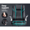 Black PU flip-arm executive chair on dark grey background with teal lines marking contoured back and seat depth insets
