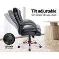 Black PU executive chair side view with tilt adjustable back and 360-degree rotation with castor wheels next to wooden desk
