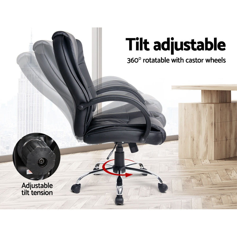 Black PU executive chair side view with tilt adjustable back and 360-degree rotation with castor wheels next to wooden desk