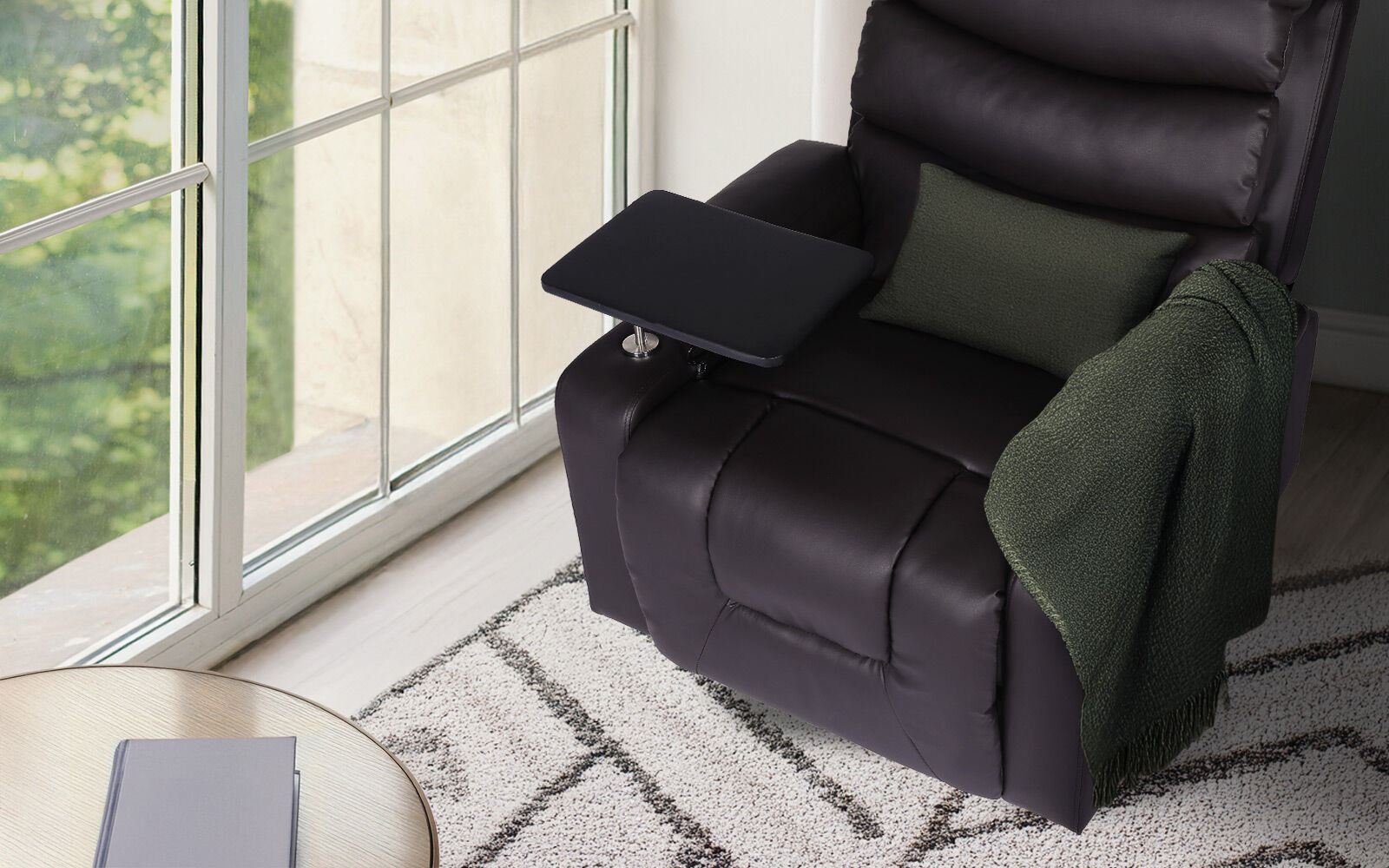 Top view of dark brown PU leather recliner with swivel tray table extended, green cushion and throw, by window