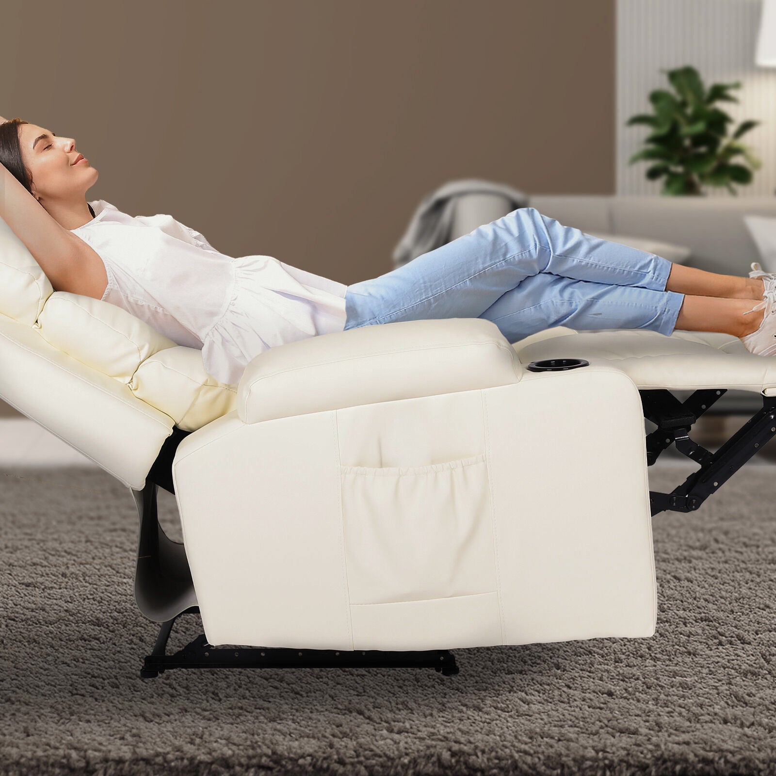 Woman lying fully reclined in cream PU leather recliner with footrest extended, cup holder and side pocket, living room