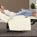 Woman fully reclined in cream tufted PU leather recliner with footrest extended and cup holder, living room setting