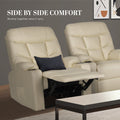Two cream tufted PU leather recliners side by side: one with footrest extended and navy cushion, one upright, in living room