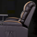 Close-up of dark brown PU leather recliner side view with amber glowing massage indicators along seat seams, dark background