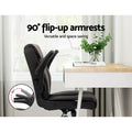 Dark brown PU mid-back chair with armrests flipped up 90 degrees in home office with desk next to window