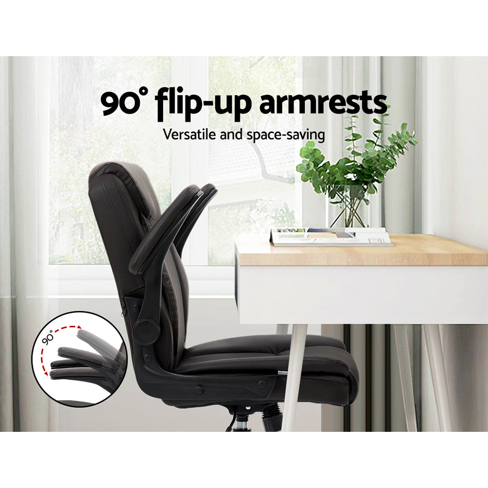 Dark brown PU mid-back chair with armrests flipped up 90 degrees in home office with desk next to window