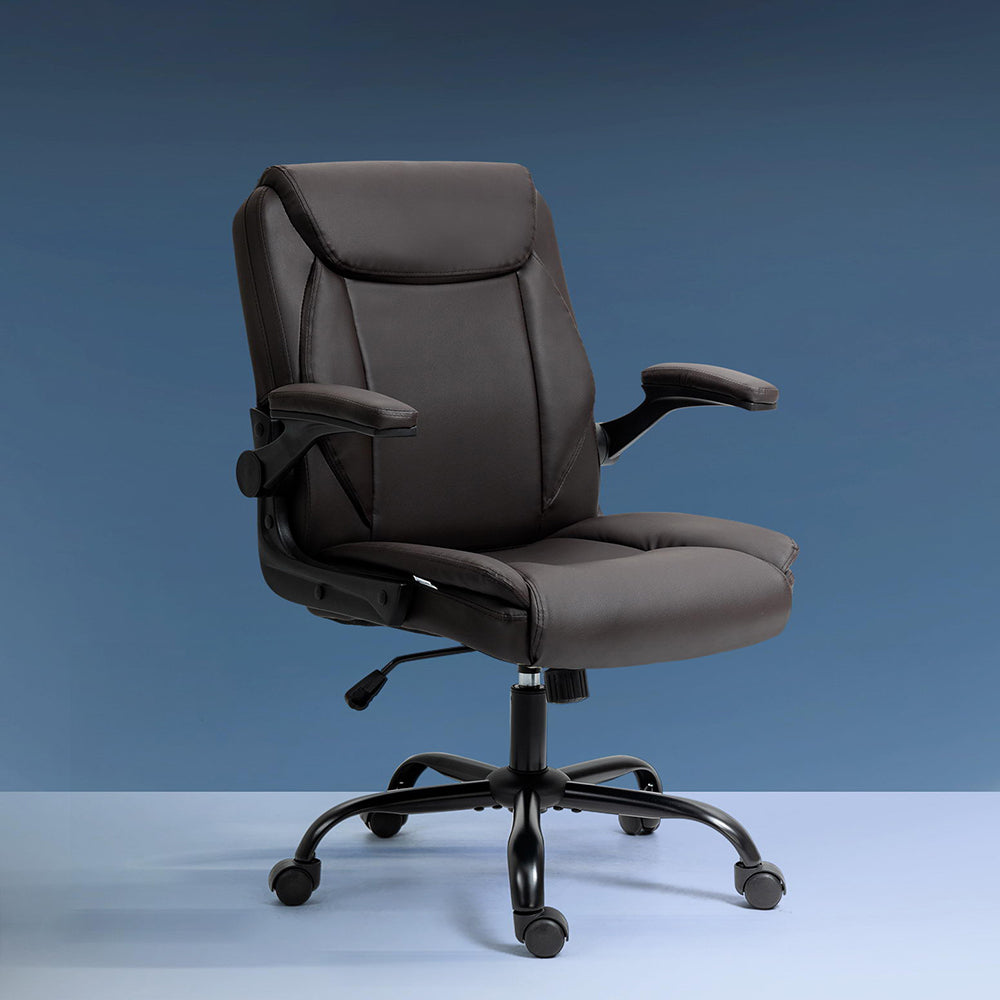 Dark brown PU leather mid-back executive chair with flip-up armrests in lowered position on blue-grey background