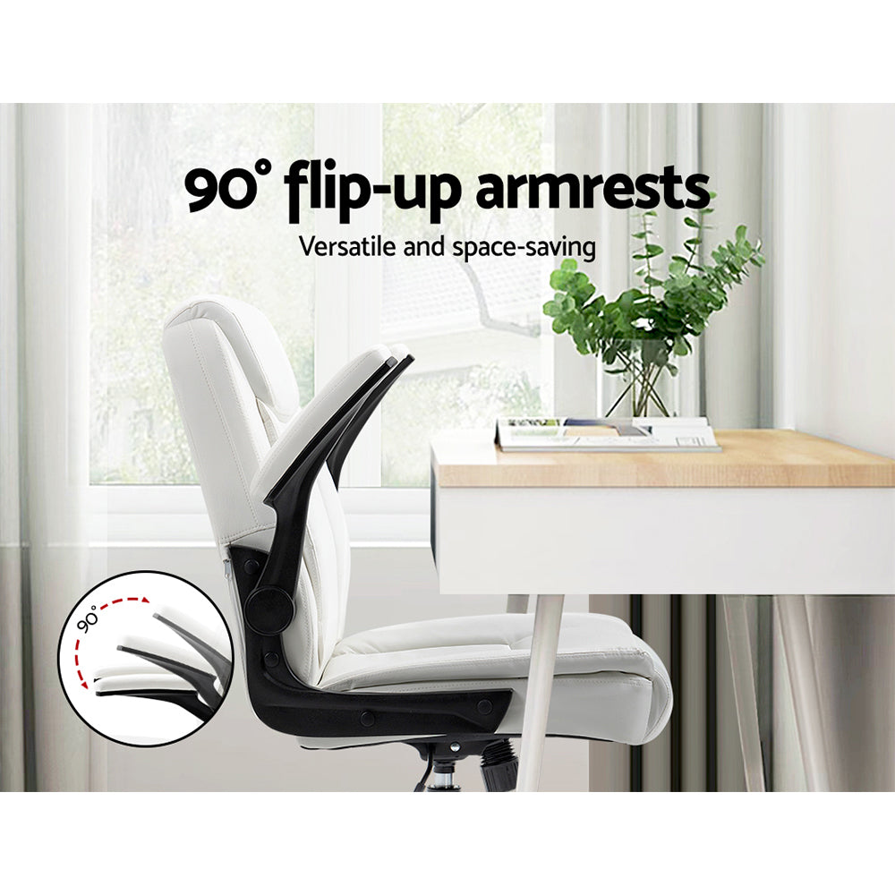White PU mid-back office chair with armrests flipped up 90 degrees in home office with desk, window and plant