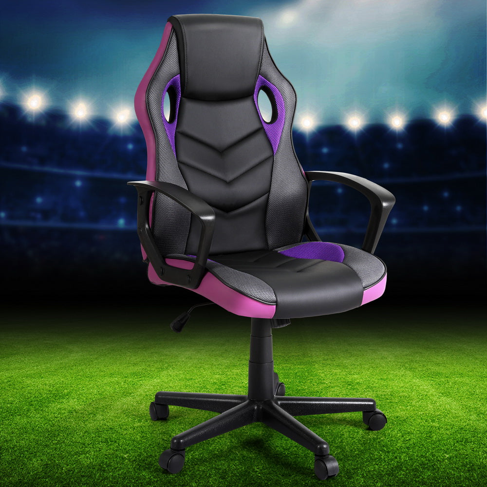 Black and purple PU mesh racing-style gaming chair angle view on stadium football pitch lifestyle background