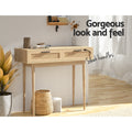Rattan oak console table in room with plant and basket; text 