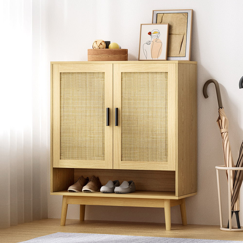 Rattan 2-door shoe cabinet with wood frame, black bar handles and open bottom shelf in hallway