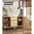 Rattan sideboard open in boho room showing shelves with baskets and books, labelled 'Aluminium handles'