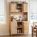 Rattan sideboard hutch open in kitchen with spice jars on top, dishes in upper cabinet, coffee machine on counter