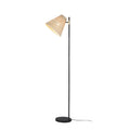 Rattan conical floor lamp shade tilted left on slim black pole with brass pivot, round flat black base, white background