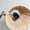 Interior of rattan lampshade showing E27 lamp socket, brass bracket and white spoke frame inside the woven shade