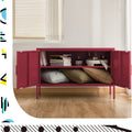 Red metal locker cabinet doors open showing interior shelf with books and cushions stored in lifestyle room setting