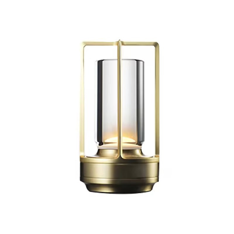 Gold retro lantern LED table lamp with rectangular metal frame and cylindrical glass tube on white background