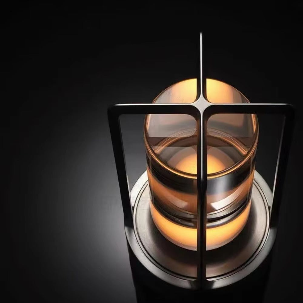 Close-up top-down view of retro lantern LED lamp showing cylindrical glass tube and amber glowing bulb in metal frame